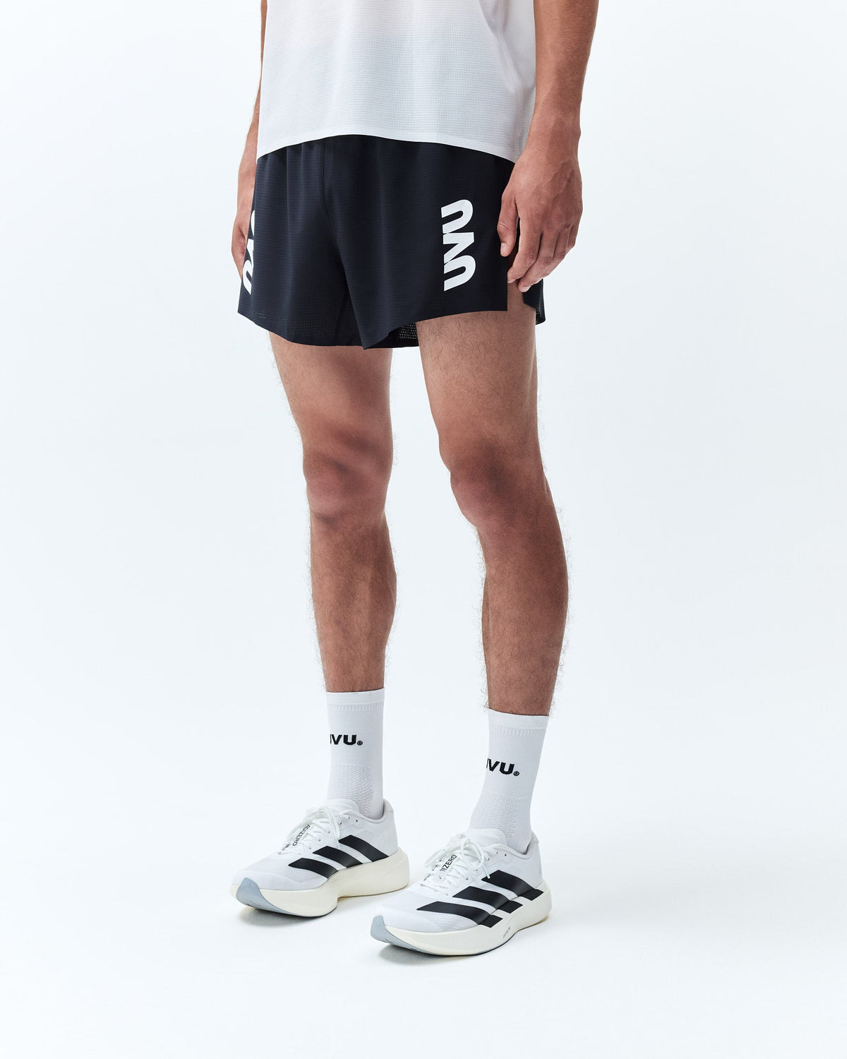 Black athletic split shorts with white logos printed vertically on both sides